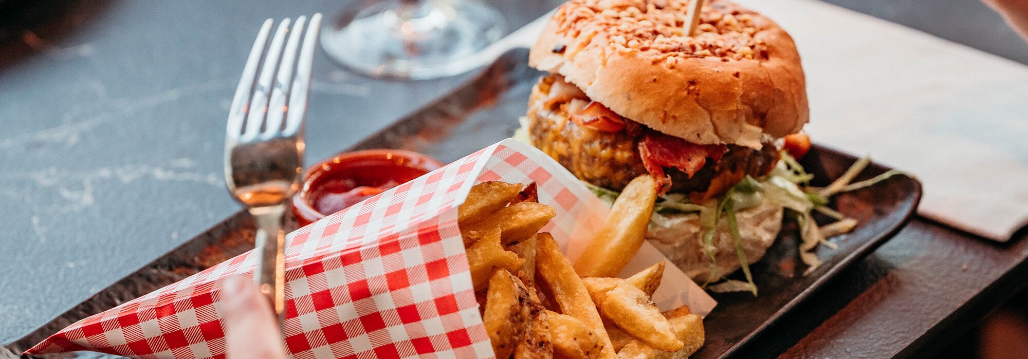 Served table with hamburger and fries at Restaurant Vlonders